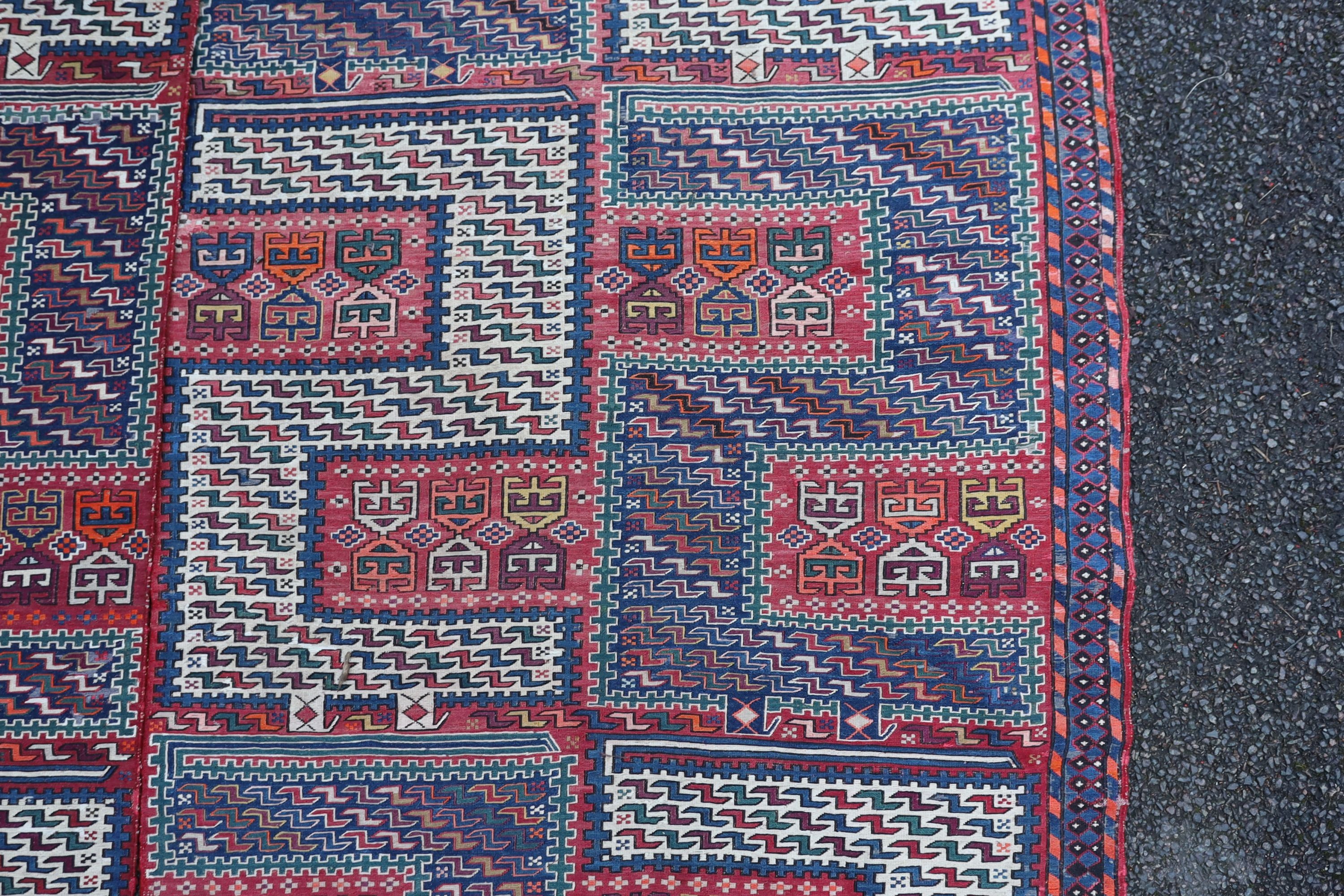 A Sumak weave 2-sectional carpet, combined dimension - 320 x 230cm.